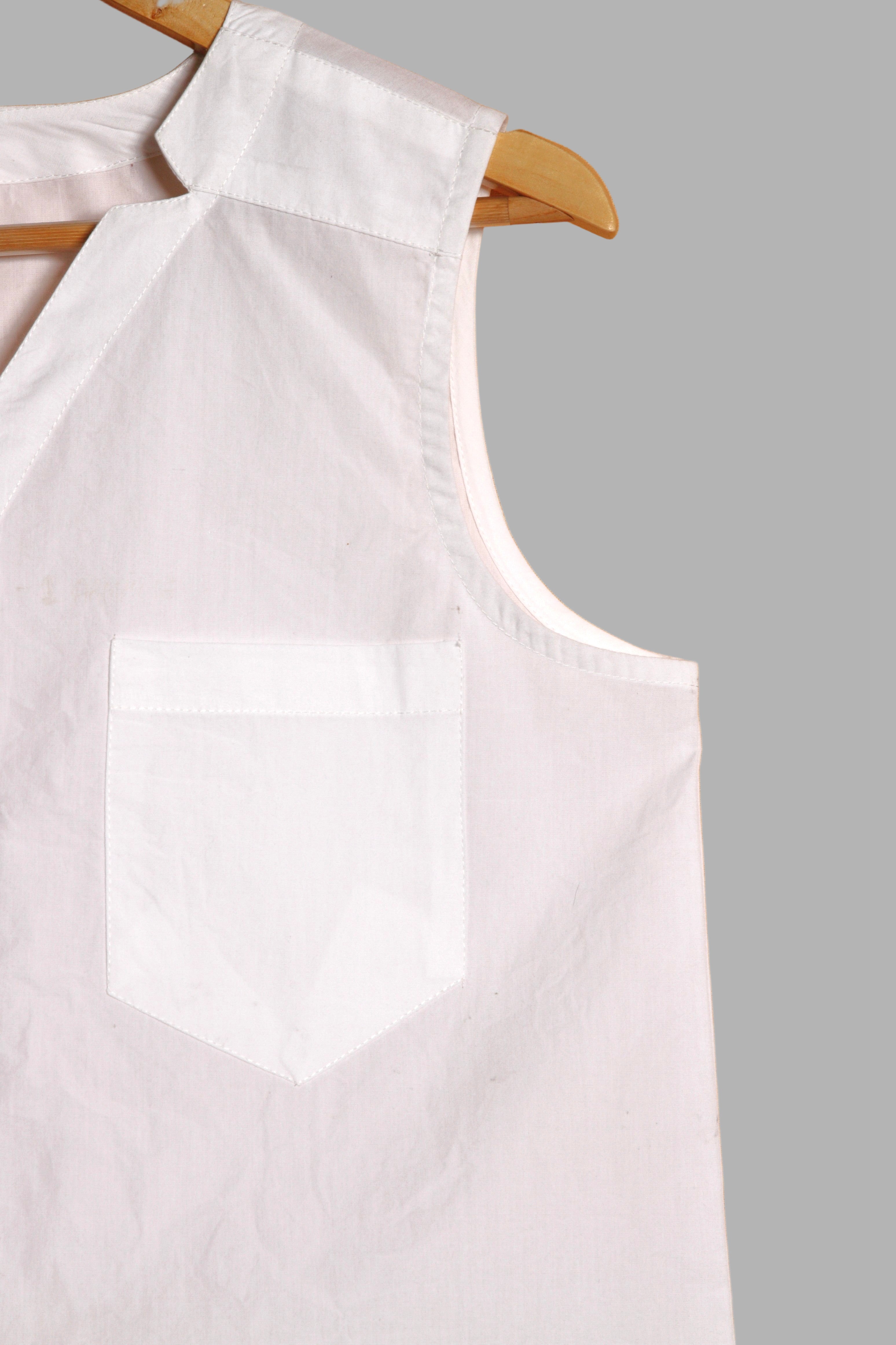 Close-up of a fullblank branded white sleeveless top called KIKI-A with a plain background