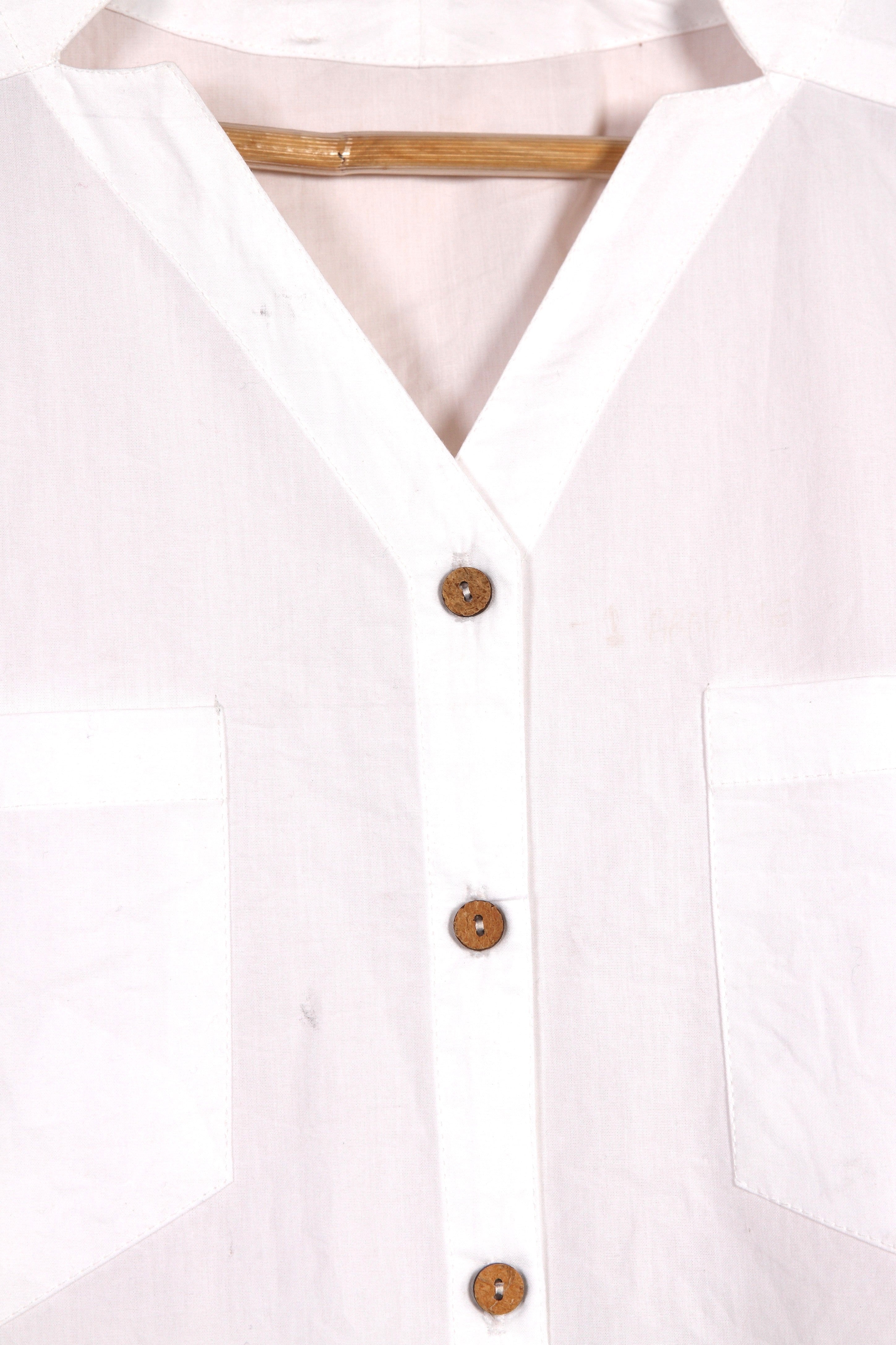 Close-up of a fullblank branded white sleeveless top called KIKI-A with a plain background