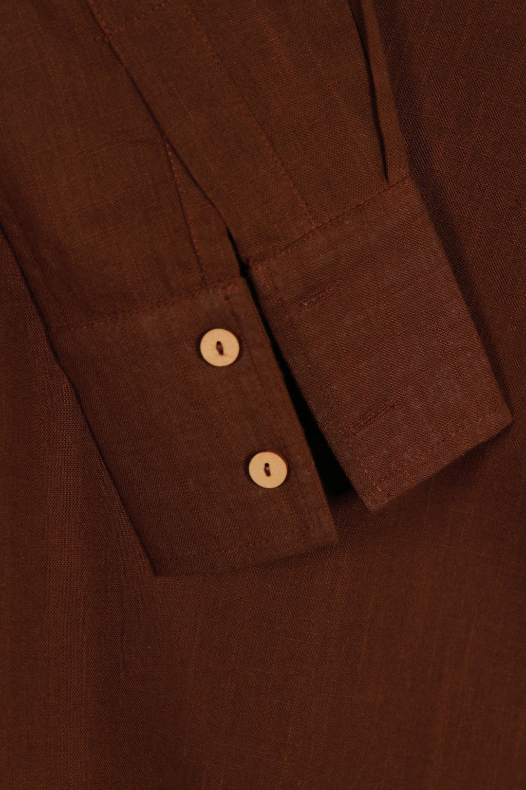 Close-up of a fullblank branded brown shirt called COCO-A with a plain background