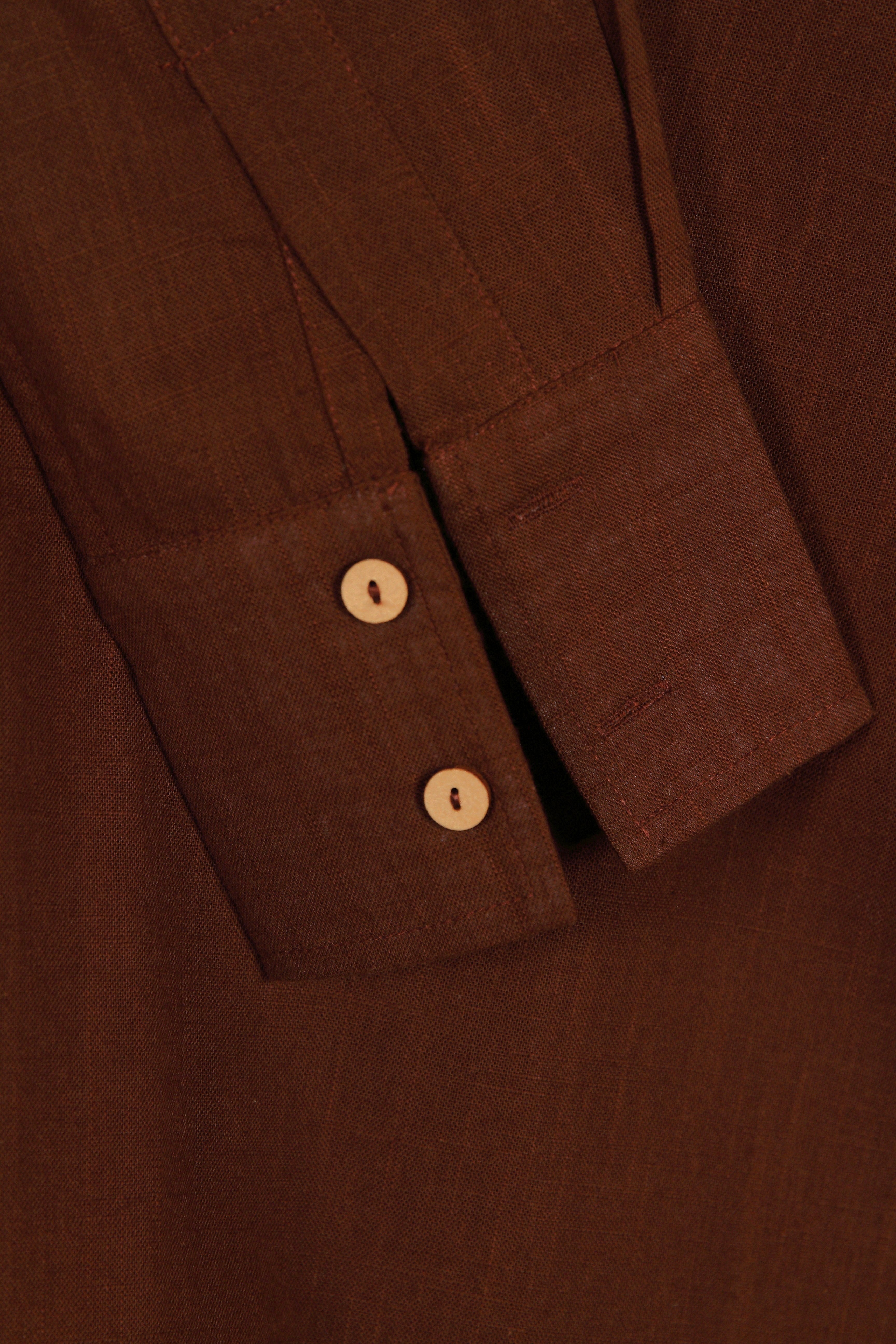 Close-up of a fullblank branded brown shirt called COCO-A with a plain background