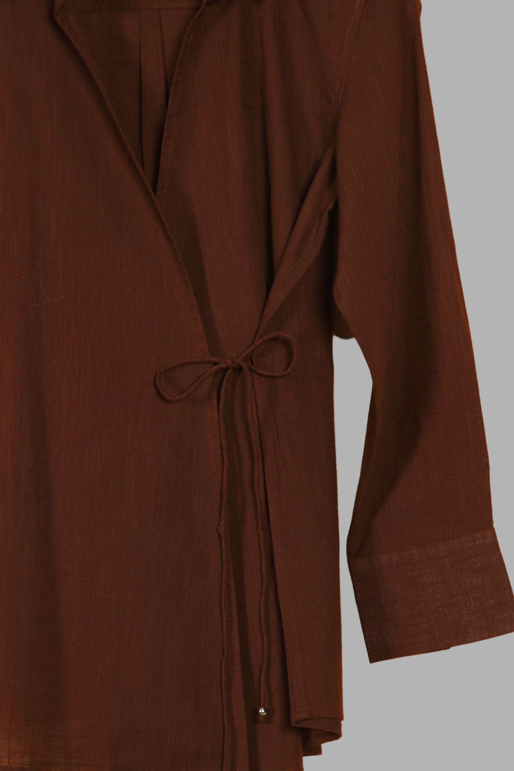 Close-up of a fullblank branded brown shirt called COCO-A with a plain background