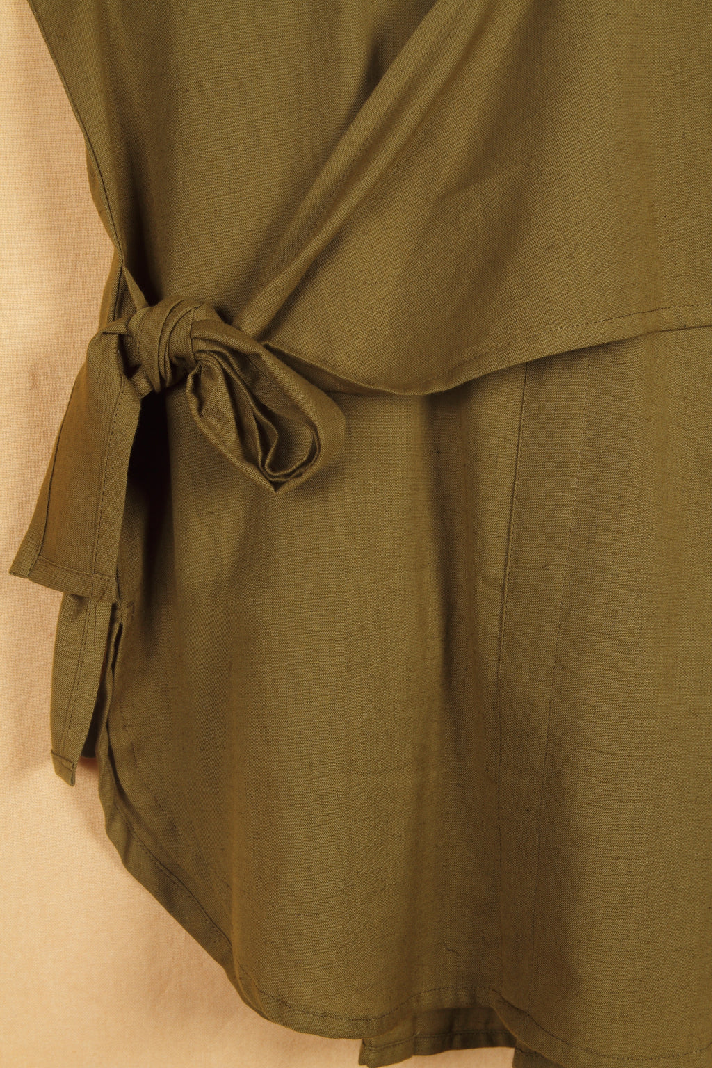 Close-up of a fullblank branded olive shirt called MIDNIGHT MUSE-A with a plain background