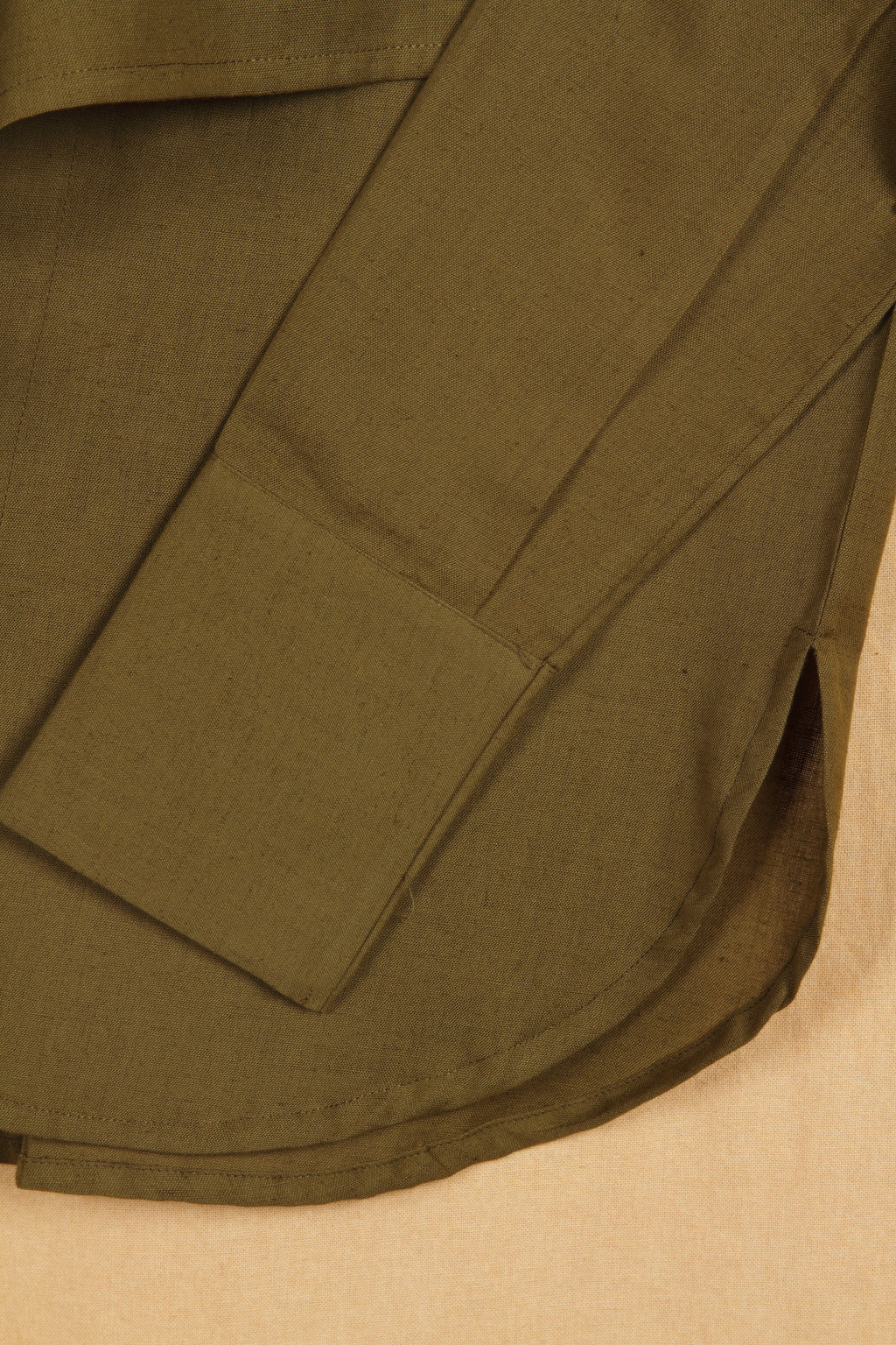 Close-up of a fullblank branded olive shirt called MIDNIGHT MUSE-A with a plain background