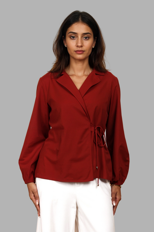 Woman wearing a fullblank branded red shirt called CLEO-A with a plain background