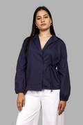 Woman wearing a fullblank branded navy blue shirt called CLEO-B with a tie detail on a plain background