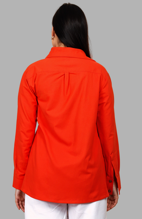 Woman wearing a fullblank branded red orange shirt called COCO-B on a plain background