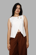 Woman wearing a fullblank branded white sleeveless top called EIRA-B with a plain background