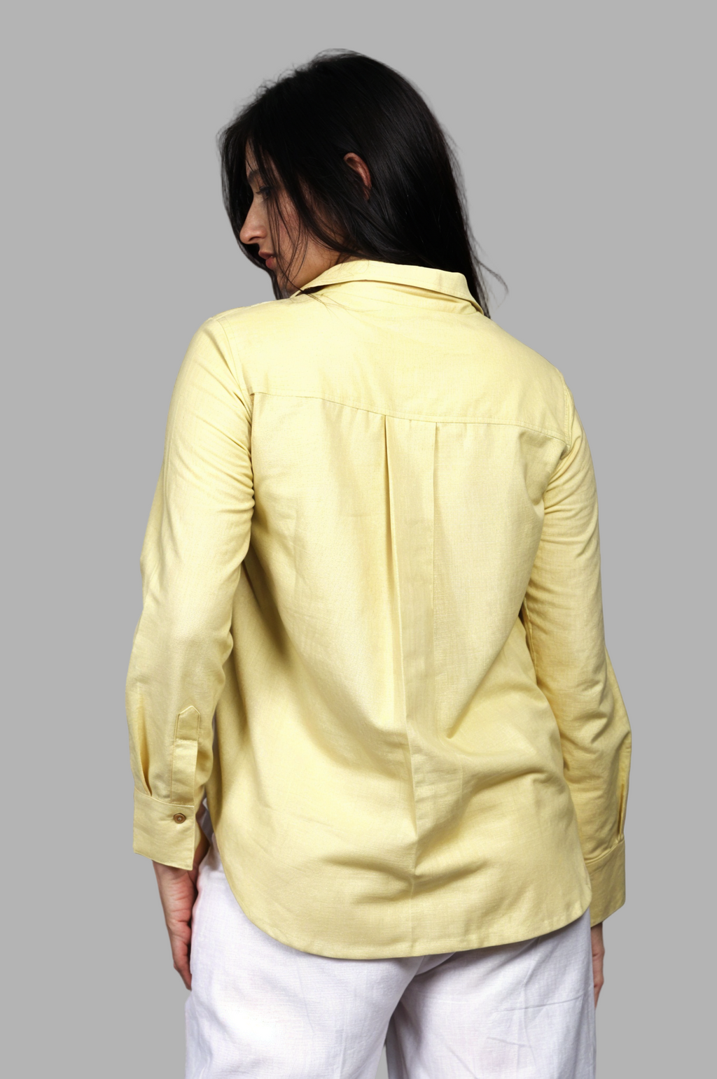 Woman wearing a fullblank branded pistachio shirt called FABLE-A with a plain background