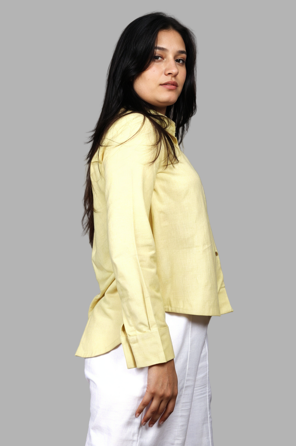 Woman wearing a fullblank branded pistachio shirt called FABLE-A with a plain background