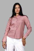 Woman wearing a fullblank branded pink shirt called FABLE-B with a plain background