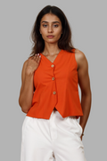 Woman wearing a fullblank branded orange sleeveless top called KIRA-A with a plain background