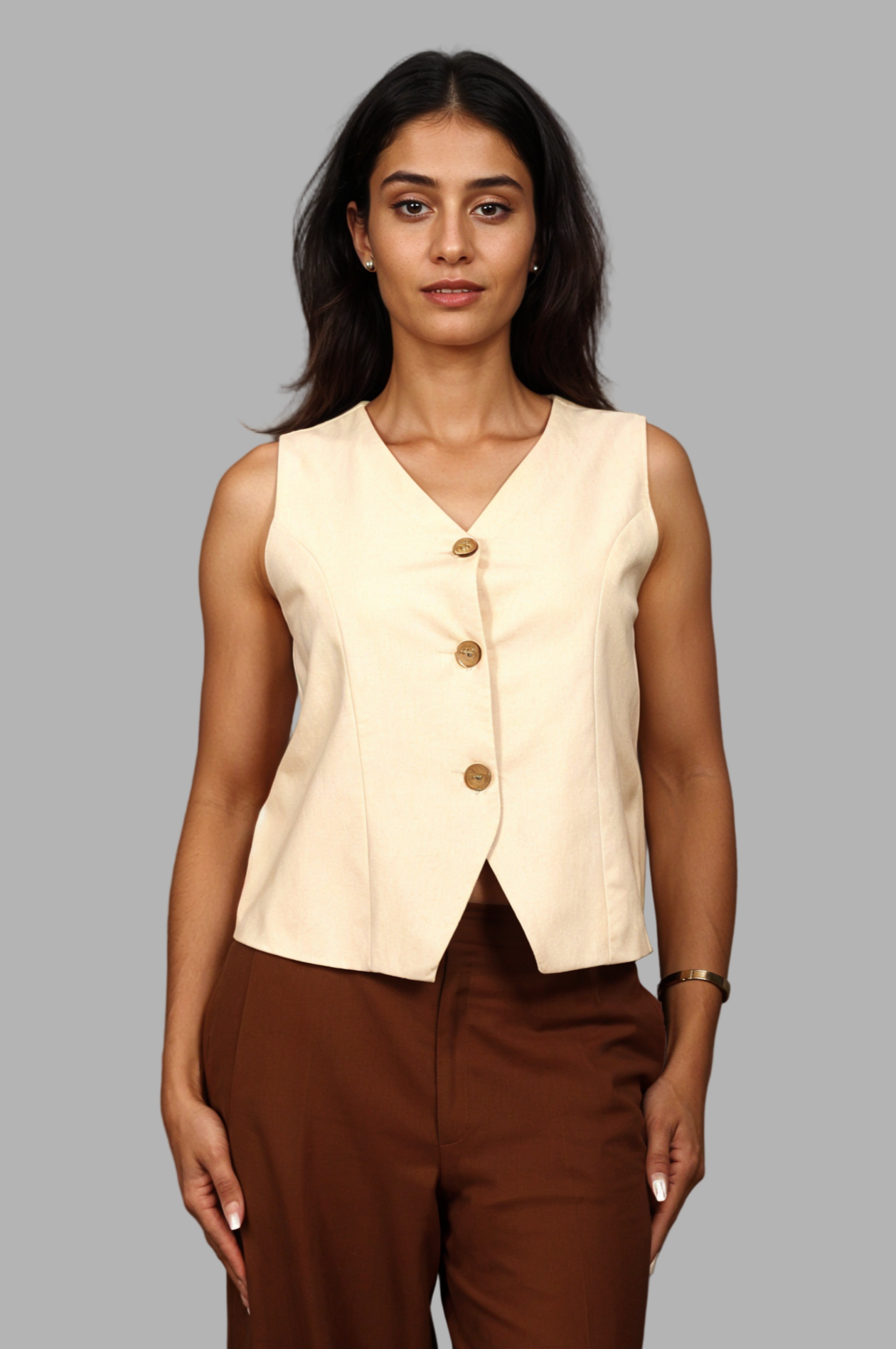 Woman wearing a fullblank branded beige vest called KIRA-B with a plain background