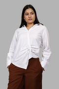 Woman wearing a fullblank branded white shirt called LAVI-A with a plain background