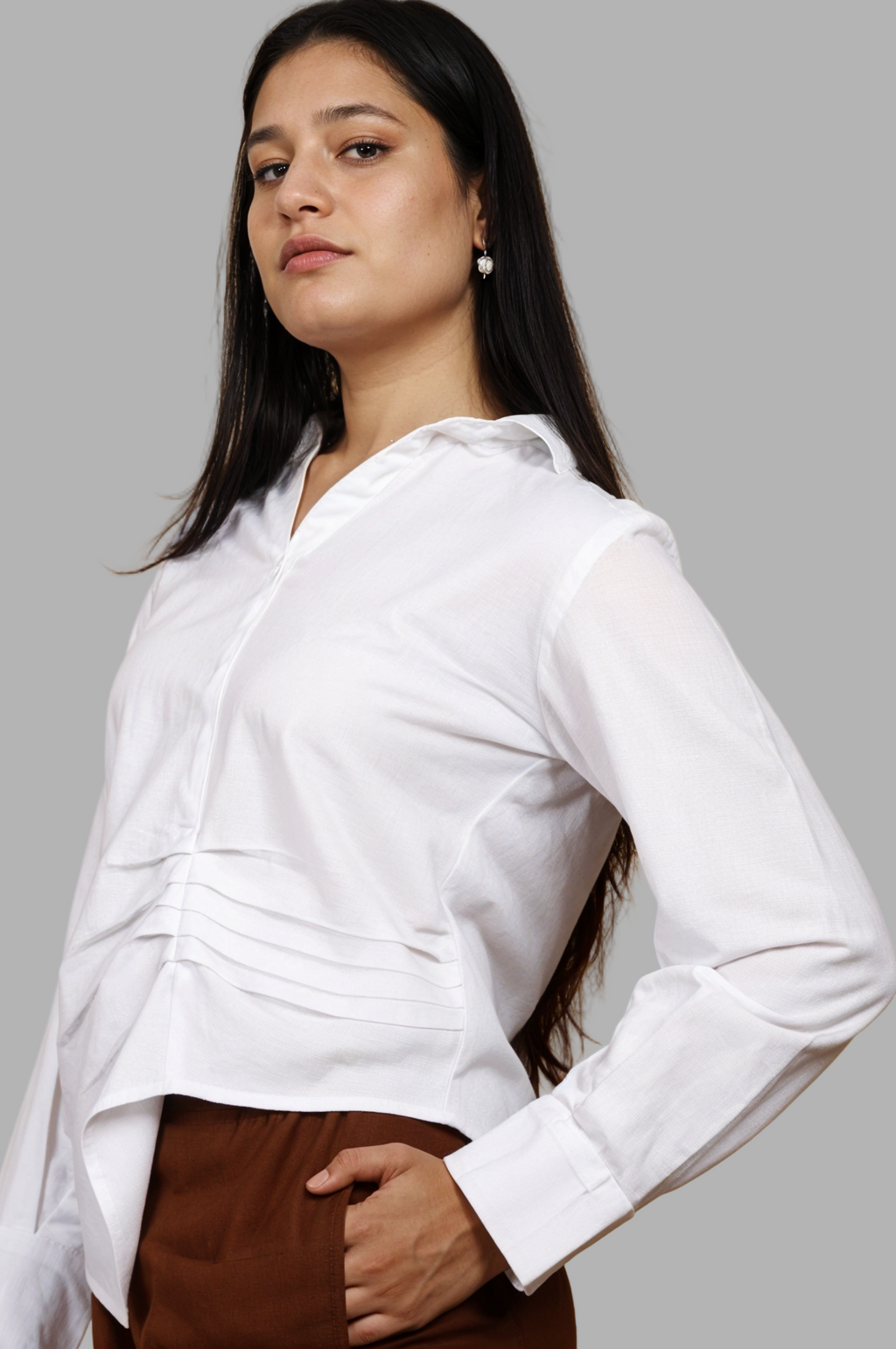 Woman wearing a fullblank branded white shirt called LAVI-A with a plain background