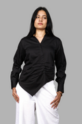 Woman wearing a fullblank branded black shirt called LAVI-B with a plain background