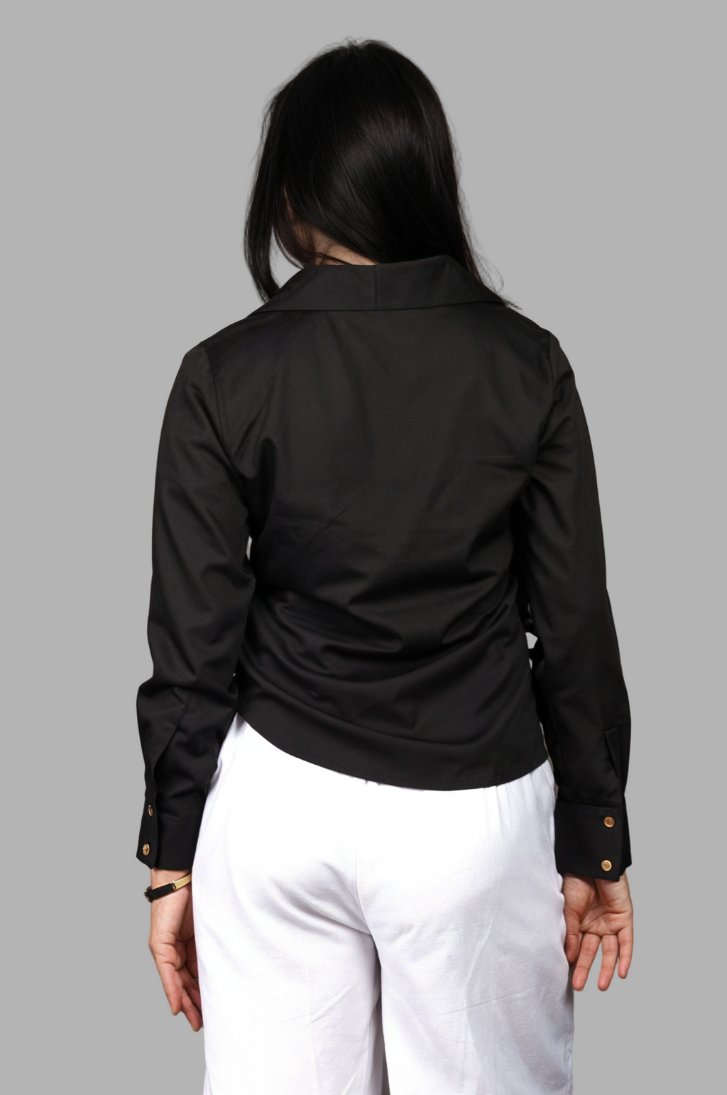 Woman wearing a fullblank branded black shirt called LAVI-B with a plain background