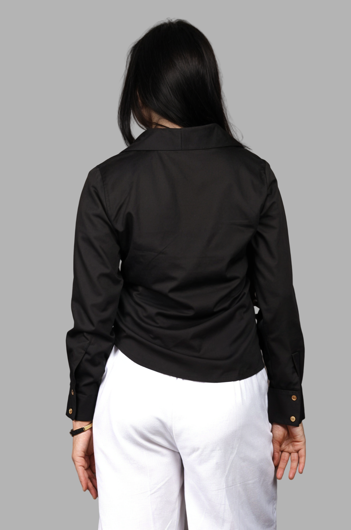 Woman wearing a fullblank branded black shirt called LAVI-B with a plain background