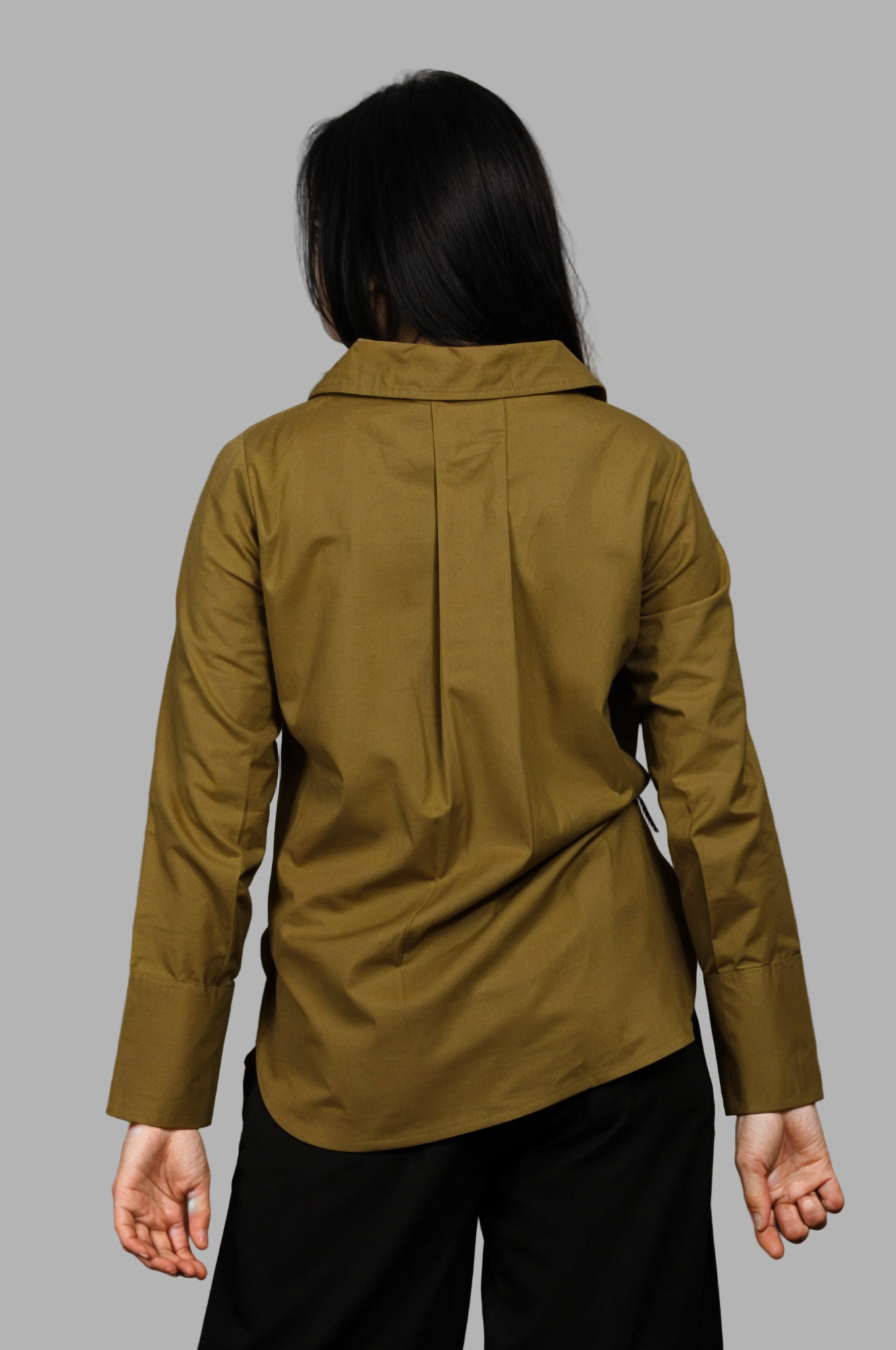 Woman wearing a fullblank branded olive shirt called MIDNIGHT MUSE-A with a plain background