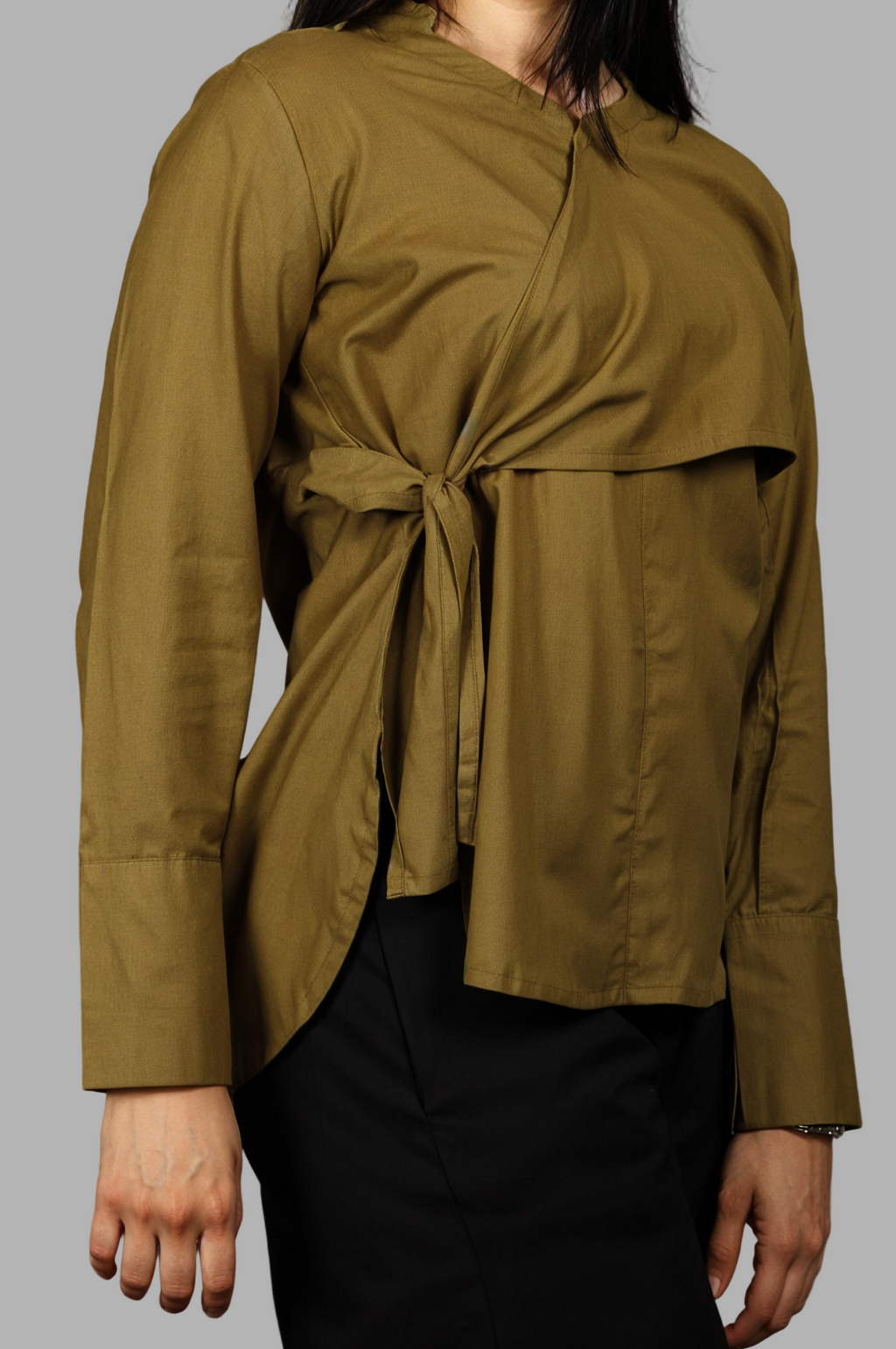 Woman wearing a fullblank branded olive shirt called MIDNIGHT MUSE-A with a plain background