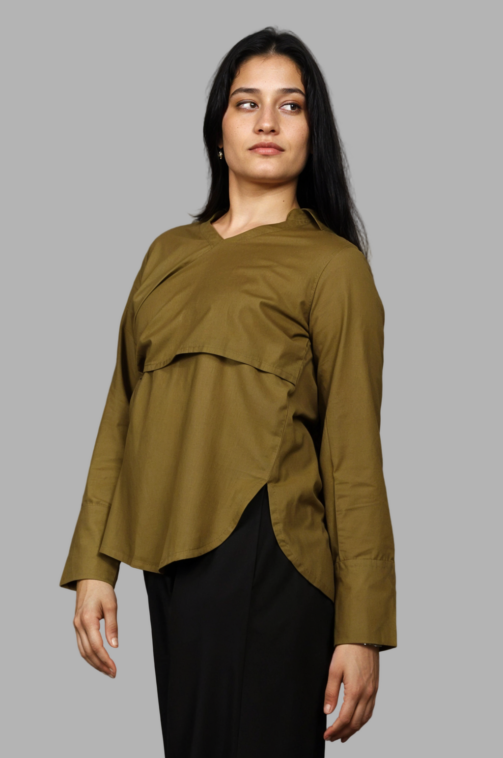 Woman wearing a fullblank branded olive shirt called MIDNIGHT MUSE-A with a plain background