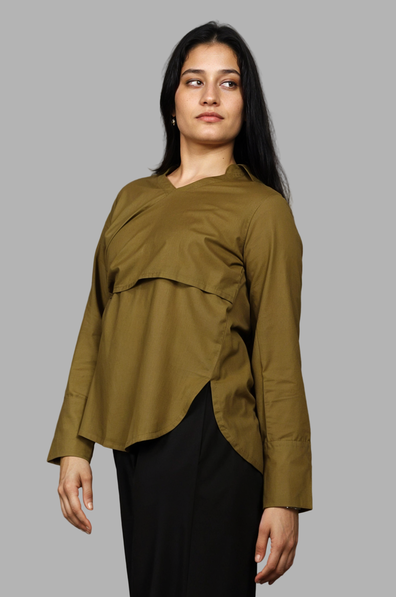 Woman wearing a fullblank branded olive shirt called MIDNIGHT MUSE-A with a plain background