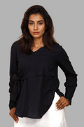 Woman wearing a fullblank branded black long-sleeve shirt called MIDNIGHT MUSE-B with a plain background
