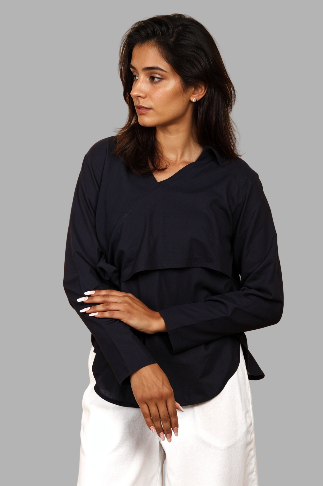 Woman wearing a fullblank branded black long-sleeve shirt called MIDNIGHT MUSE-B with a plain background