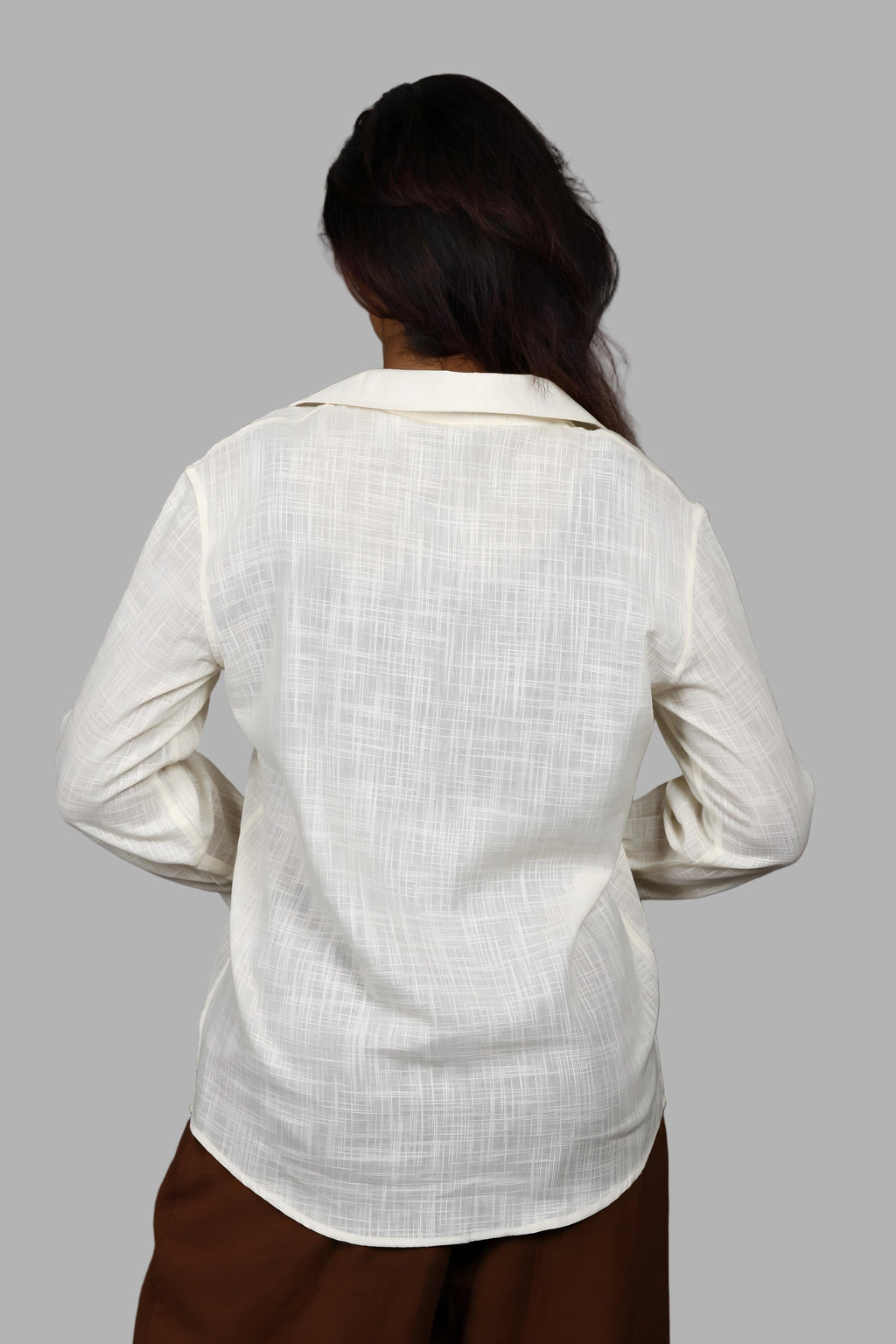 Woman wearing a fullblank branded light yellow shirt called PEARL-A with a plain background