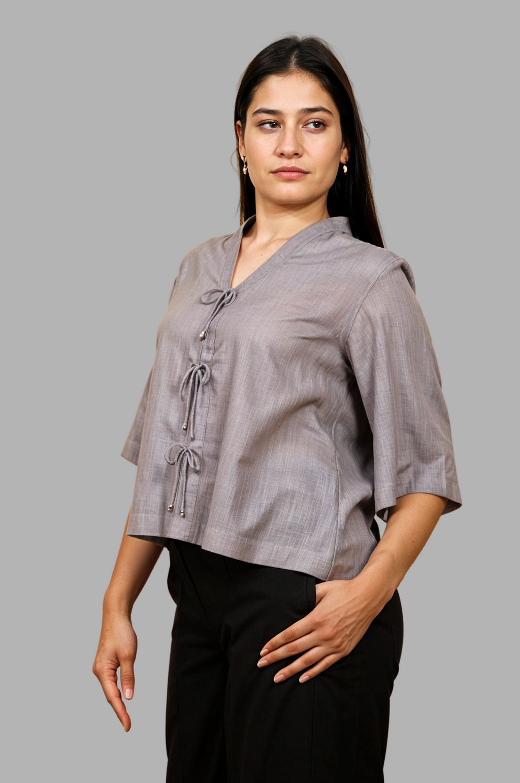 Woman wearing a fullblank branded gray top called RIVA-A with a plain background