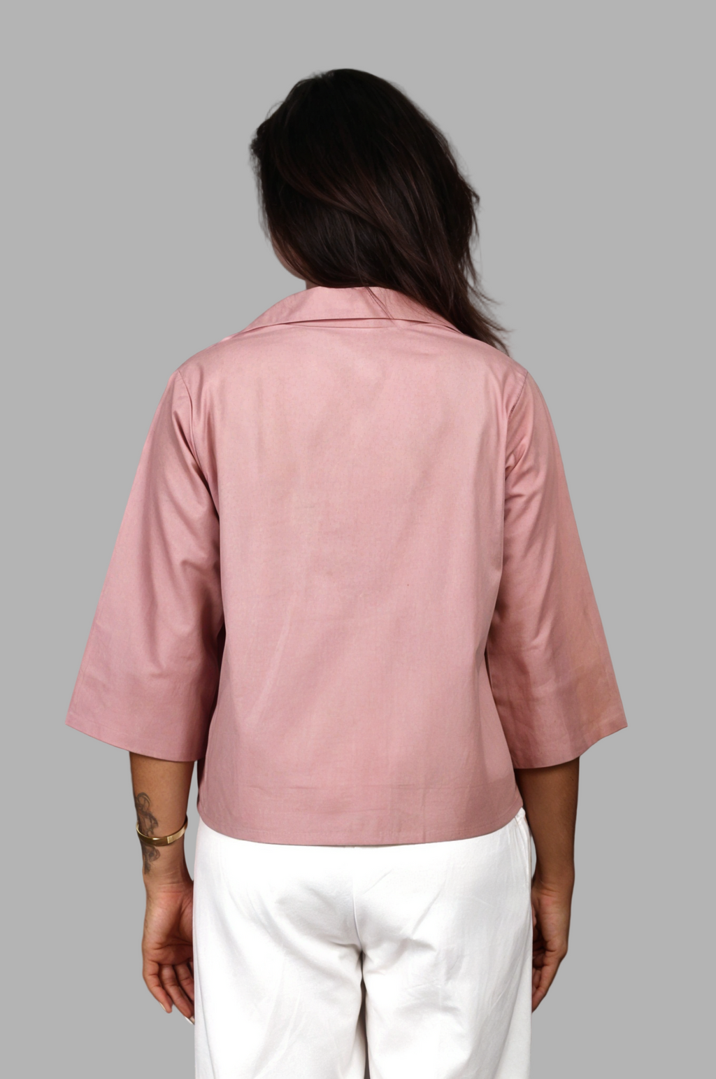Woman wearing a fullblank branded white shirt called SIRA-A with a plain background