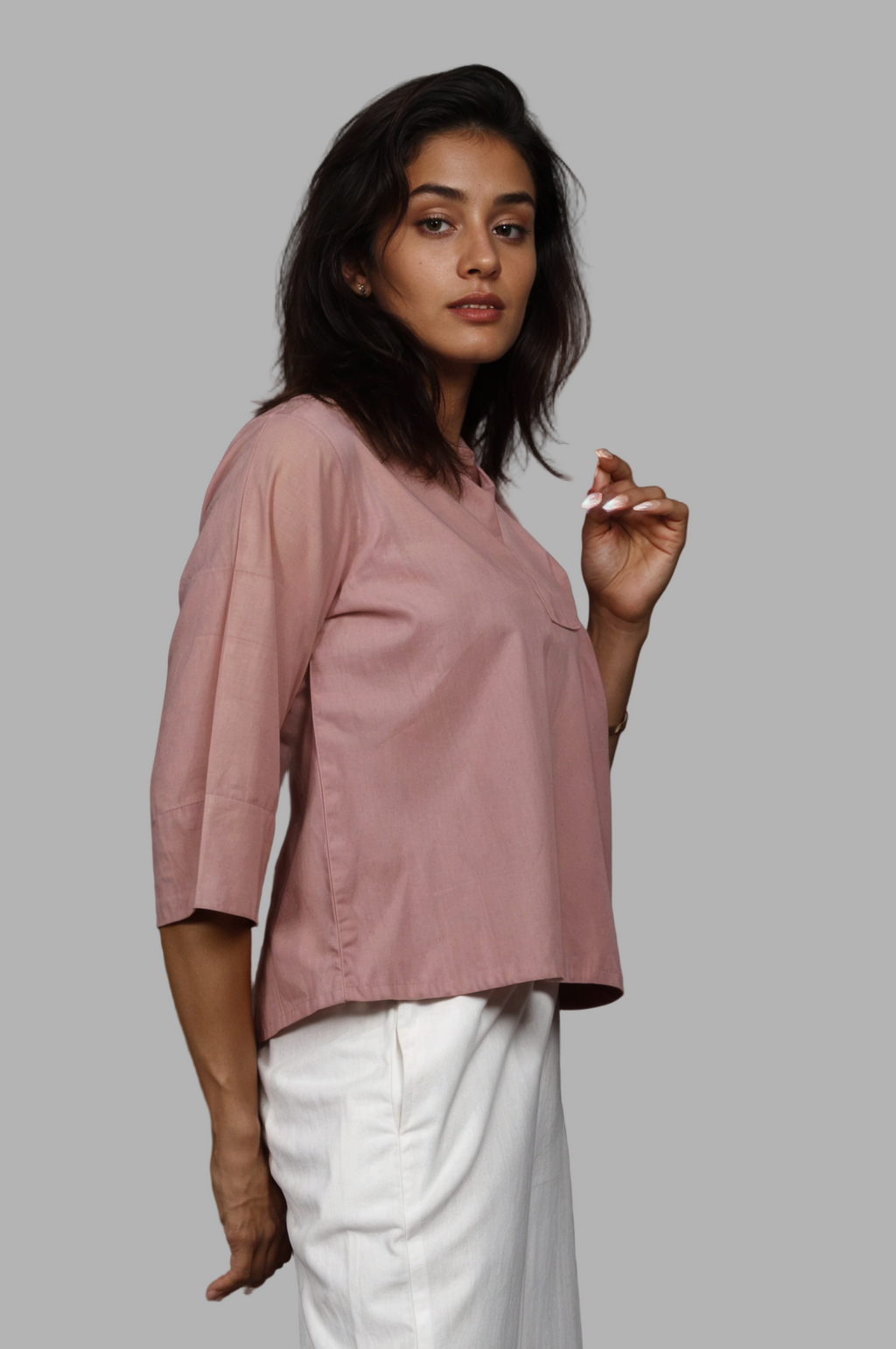 Woman wearing a fullblank branded white shirt called SIRA-A with a plain background