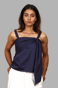 Woman wearing a fullblank branded navy blue top with a bow detail called TWIXY-A with a plain background