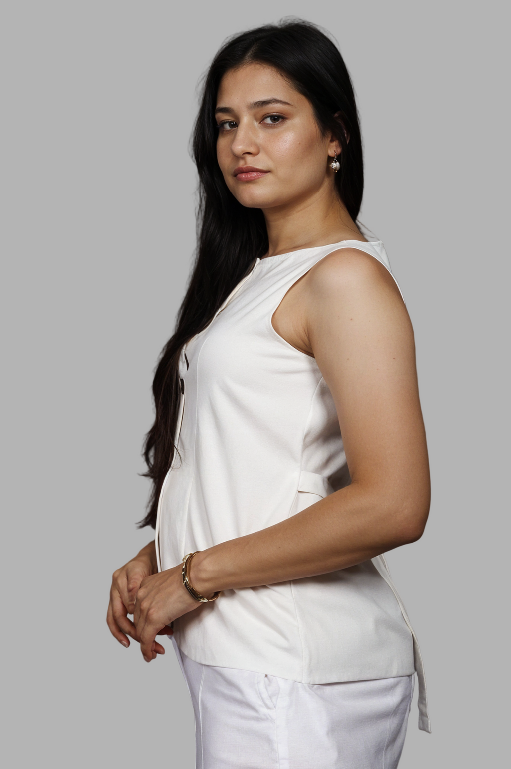 Woman wearing a fullblank branded white vest called ZENA-A with a plain background