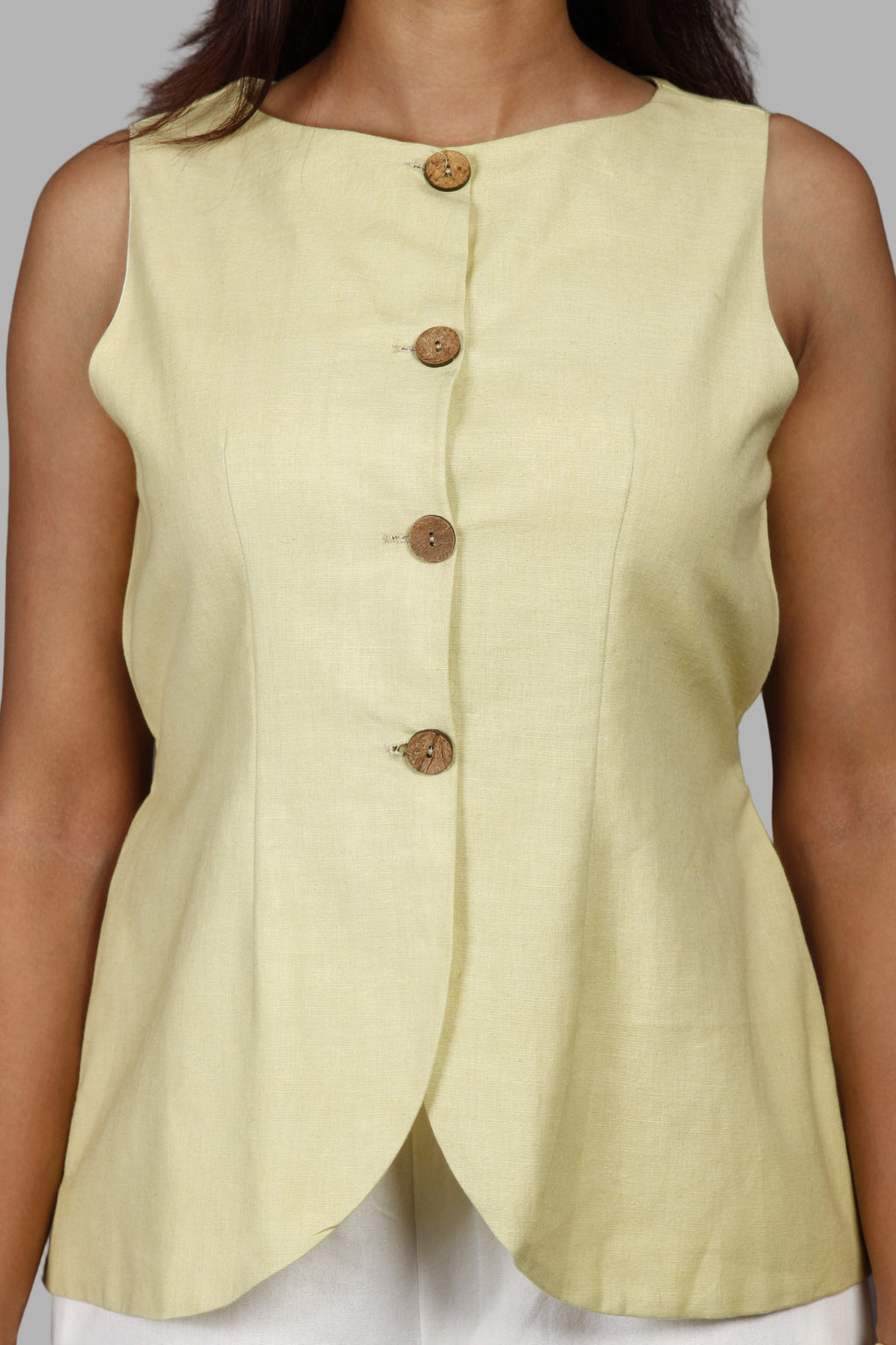 Woman wearing a fullblank branded pistachio vest called ZENA-B with a plain background