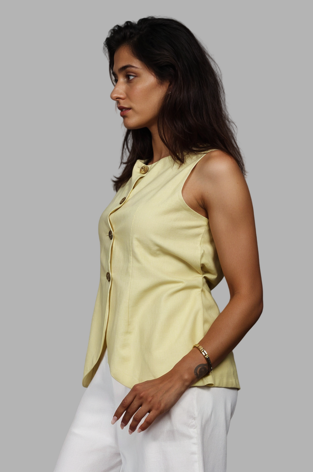 Woman wearing a fullblank branded pistachio vest called ZENA-B with a plain background